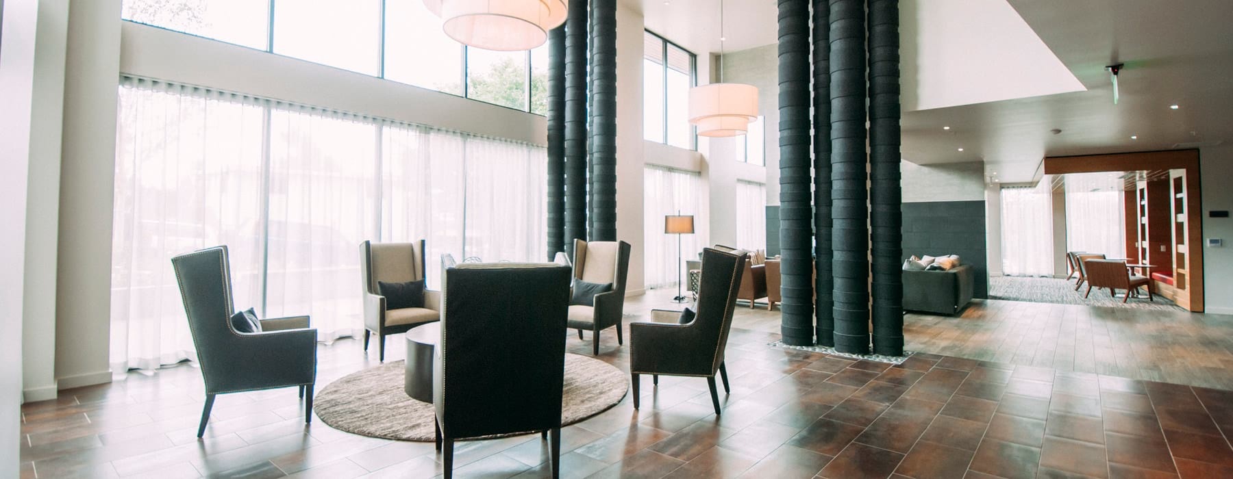 floor-to-ceiling windows in bright clubhouse